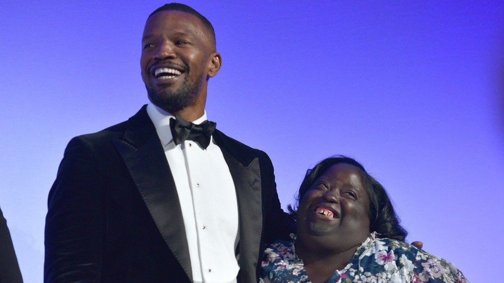 Jamie Foxx and sister DeOndra Dixon laughing at the Global Down Syndrome Foundation 10th anniversary event in 2018