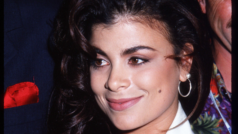 Paula Abdul wears white and a hoop earring