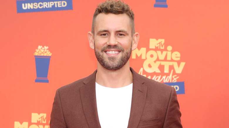 Nick Viall smiling brown blazer