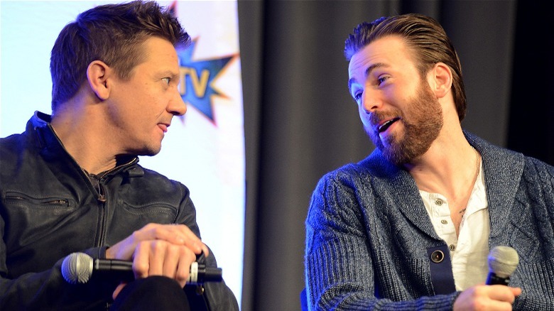 Jeremy Renner and Chris Evans holding mics, speaking