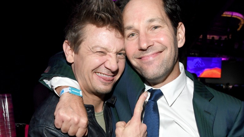 Jeremy Renner sticking his tongue out and pointing at Paul Rudd