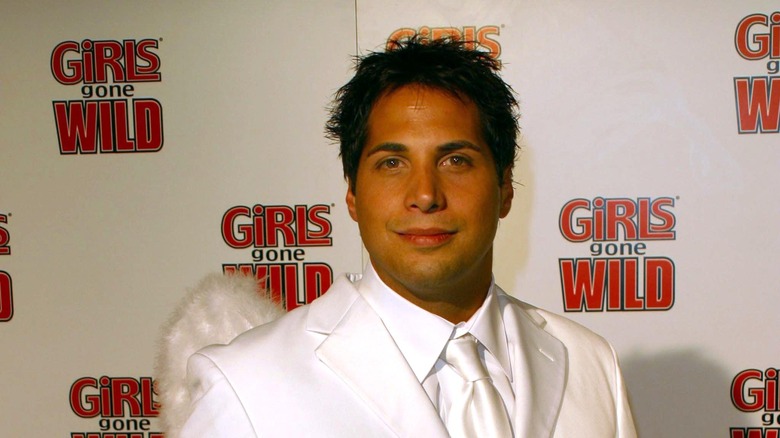 Joe Francis wearing white suit red carpet