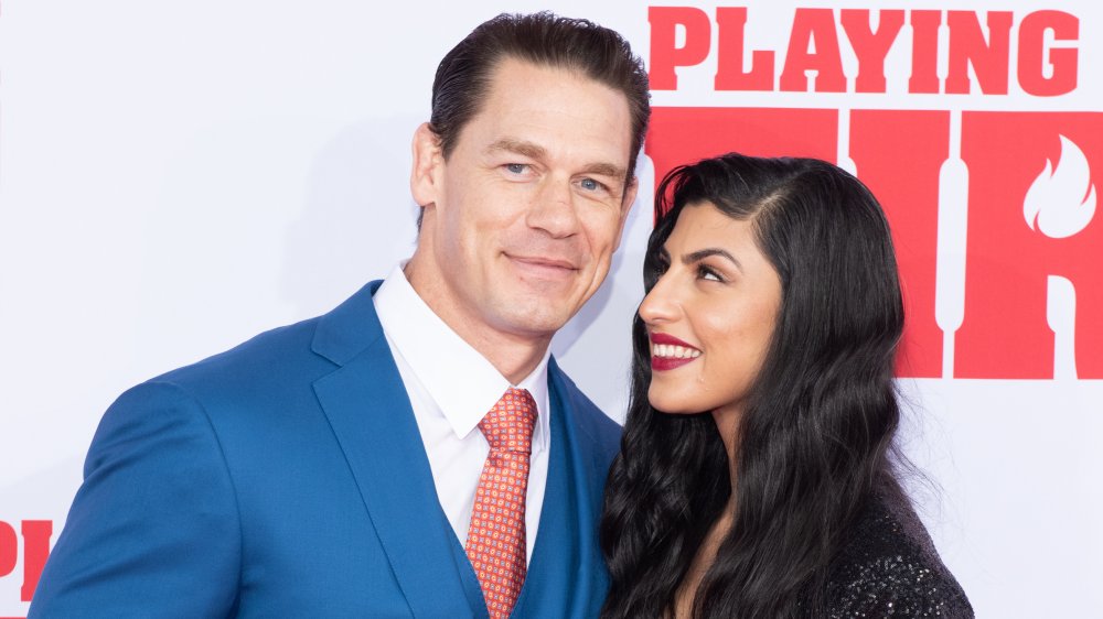 John Cena and Shay Shariatzadeh smiling on the red carpet 