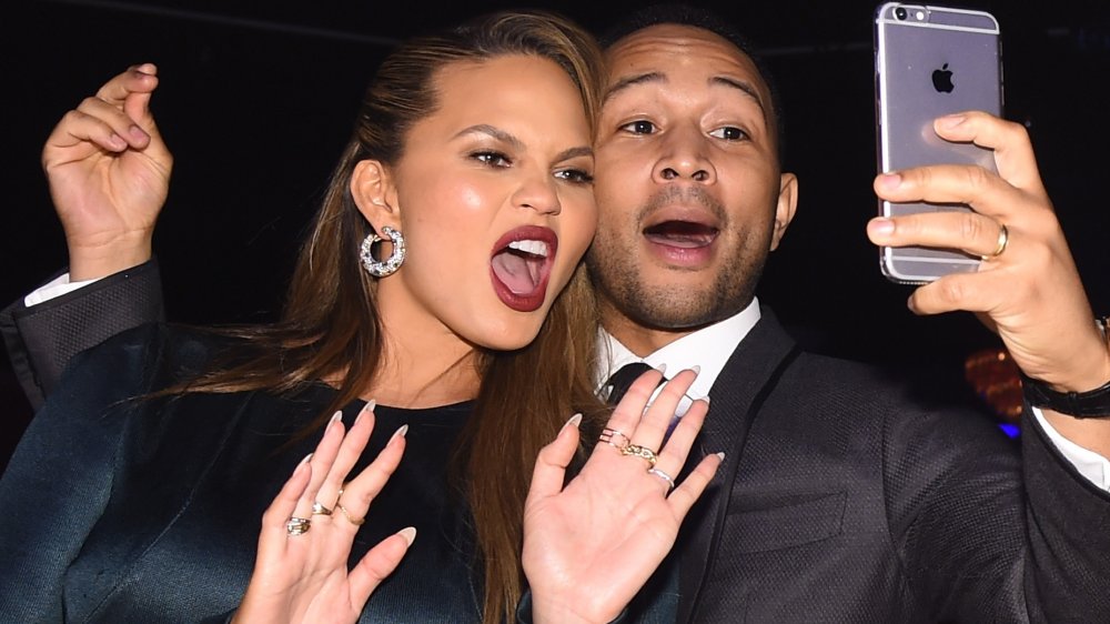 Chrissy Teigen and John Legend taking a selfie