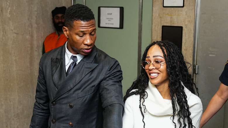 Jonathan Majors and Meagan Good walking