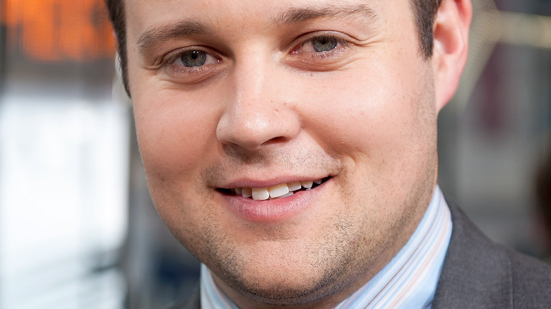 Josh Duggar smiles at an event