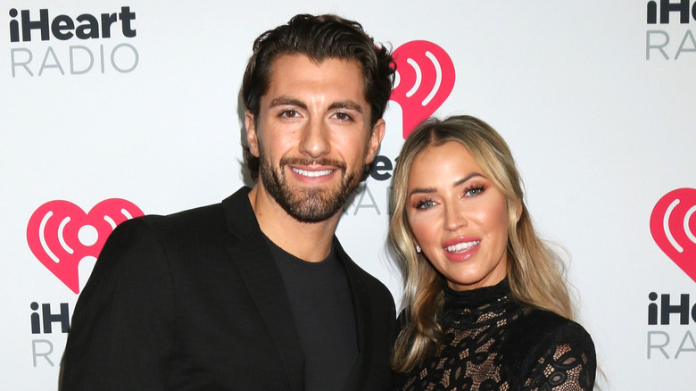 Kaitlyn Bristowe and Jason Tartick posing at a red carpet event