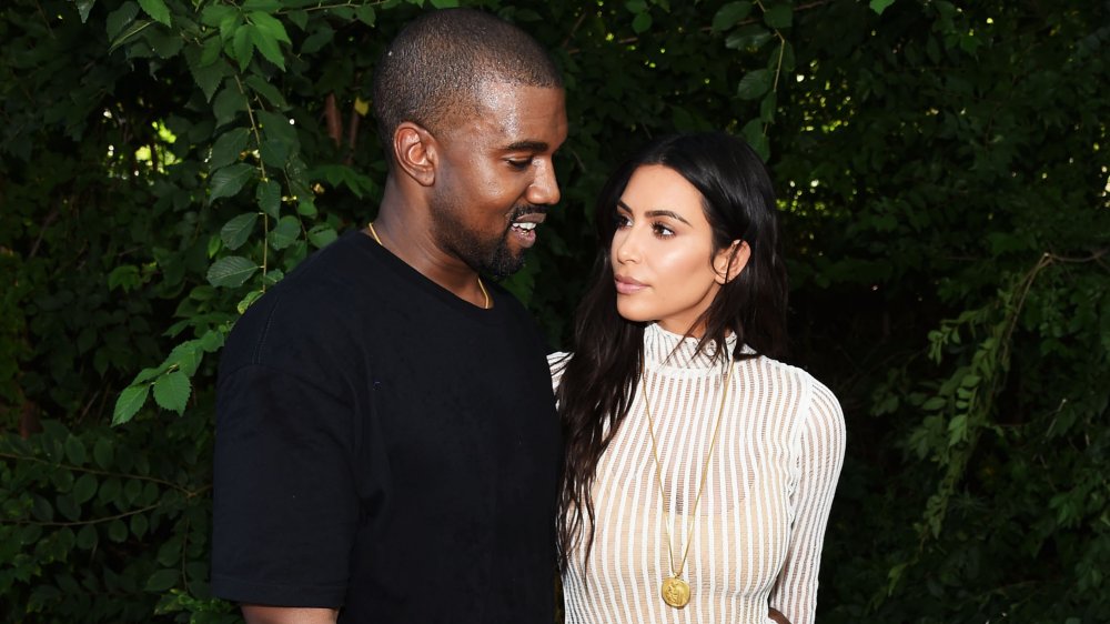 Kanye West and Kim Kardashian looking at one another 