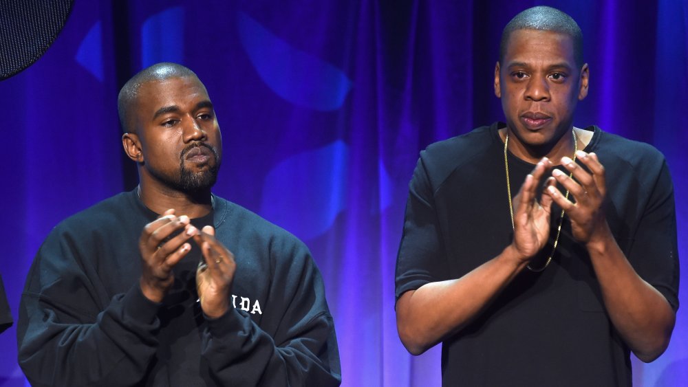 Kayne West and Jay-Z both clapping on stage