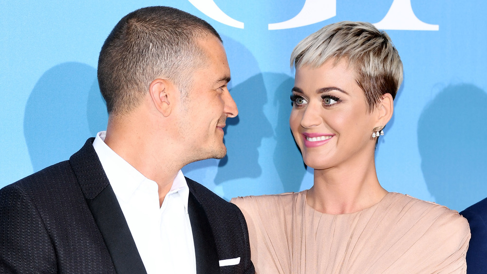 Orlando Bloom and Katy Perry smiling at each other