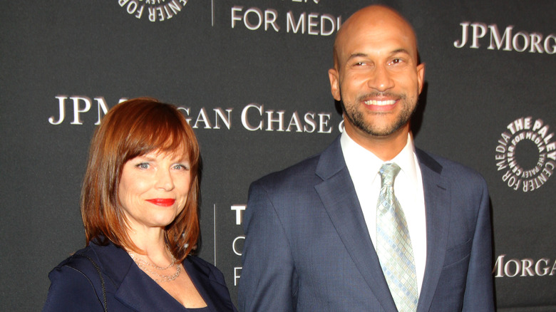 Cynthia Blaise smirking next to Keegan-Michael Key smiling 