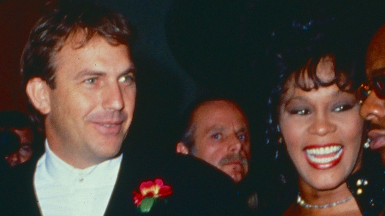 Kevin Costner and Whitney Houston pose at a premiere