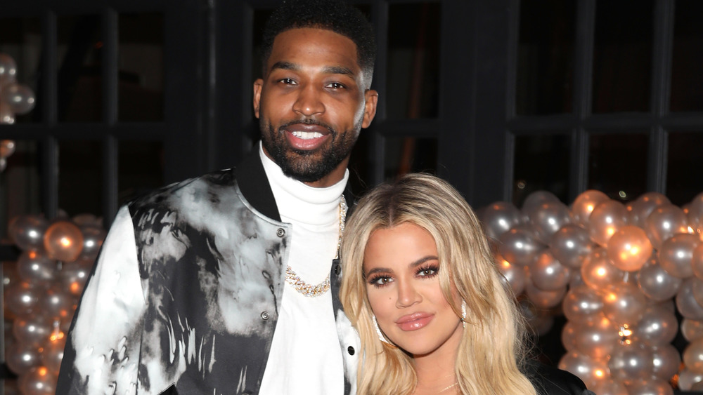 Khloe Kardashian and Tristan Thompson attending a party