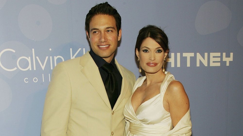 Eric Villency and Kimberly Guilfoyle in front of Calvin Klein promo wall