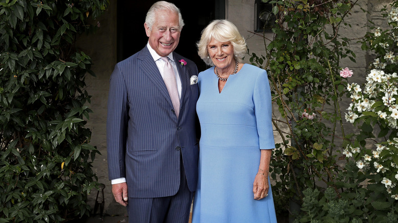 King Charles and Queen Camilla posing outdoors