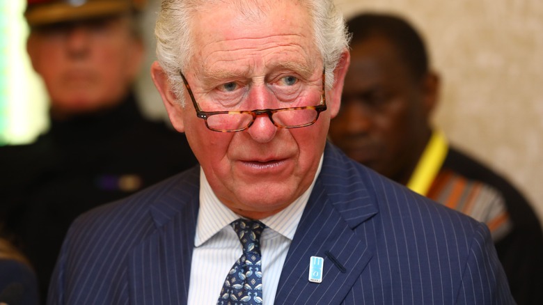 King Charles posing, glasses on nose