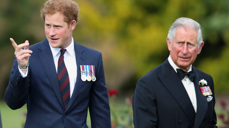 Charles and Harry walking, Harry poining