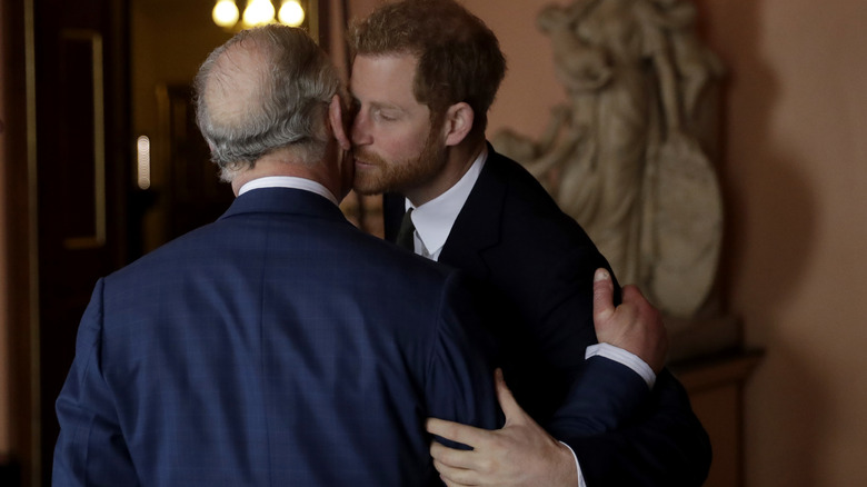 Harry and Charles kissing and embracing