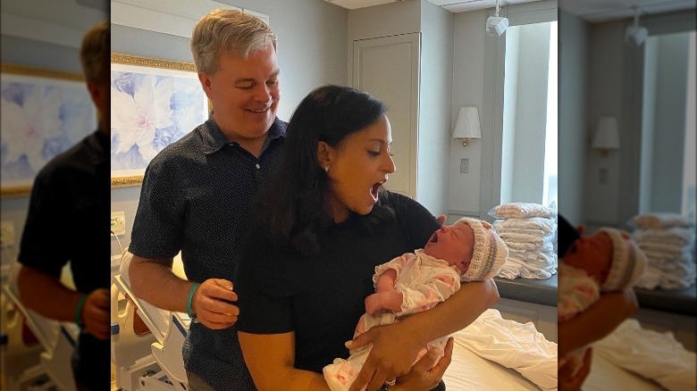 Kristen Welker and John Hughes holding their baby