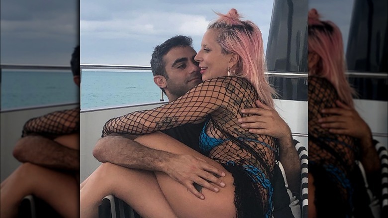 Lady Gaga and Michael Polansky embracing on boat