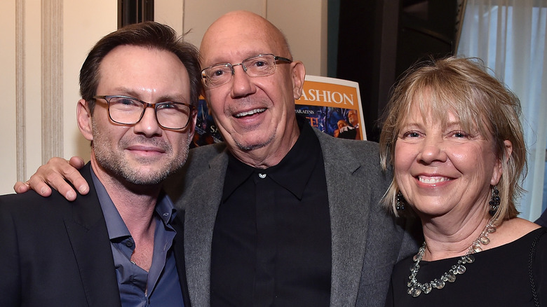 Dann and Karen Florek smiling alongside Christian Slater