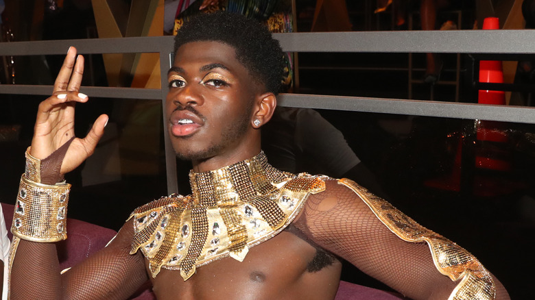 Lil Nas X posing in a performance costume