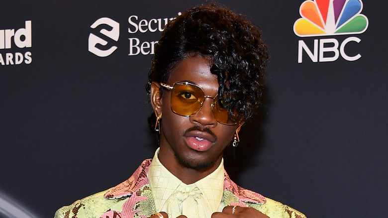 Lil Nas X wearing glasses and posing