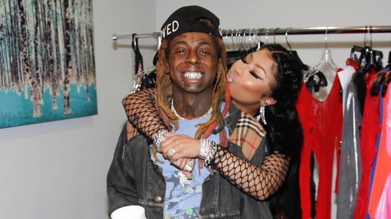 Nicki Minaj with arms around Lil Wayne