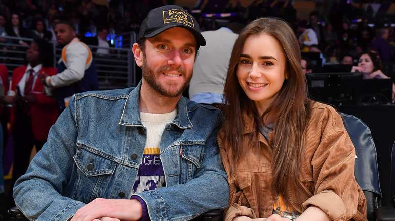 Lily Collins and Charlie McDowell sitting courtside