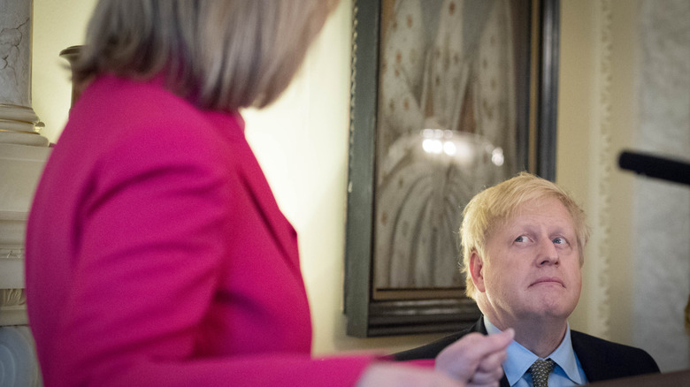 Boris Johnson listening to Liz Truss