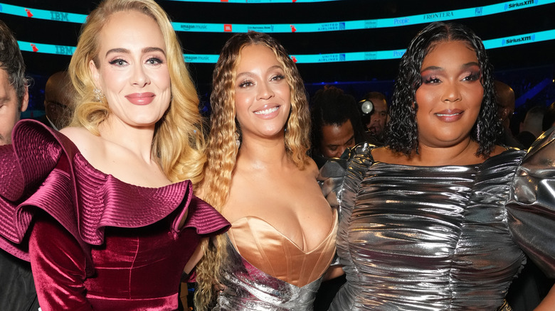 Adele and Lizzo smiling with Beyoncé