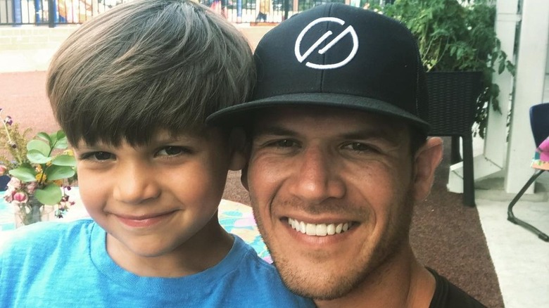 Josh Hughes and his son, smiling at camera