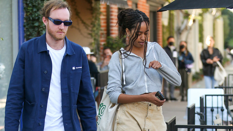 Malia Obama walking with a friend