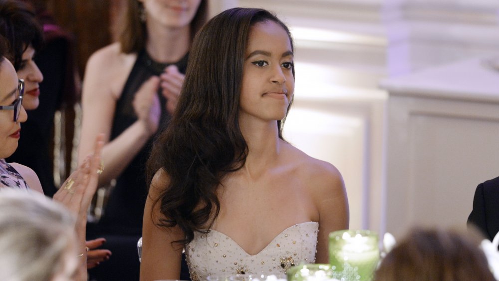 Malia Obama with a neutral expression, at a dinner