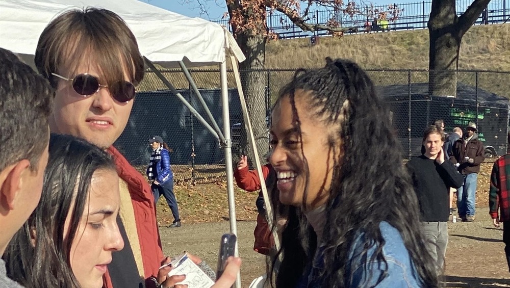 Rory Farquharson with a neutral expression, and Malia Obama laughing