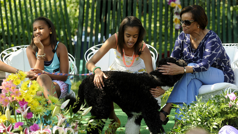 Sasha and Malia Obama pet dog with Marian Robinson