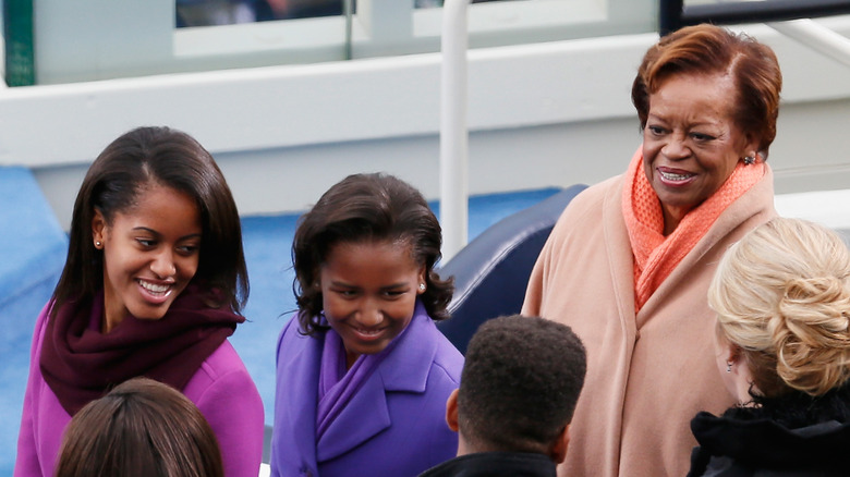 Sasha and Malia Obama smiling with Marian Robinson