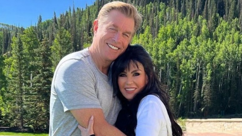 Steve Craig and Marie Osmond pose by a mountain range