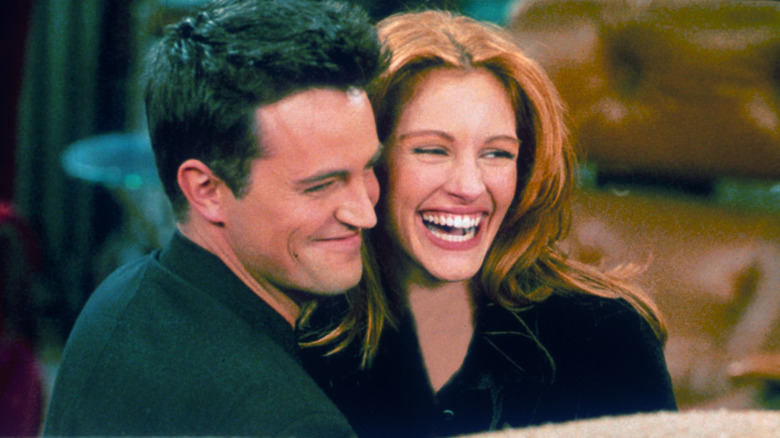 Matthew Perry and Julia Roberts hugging each other on set of "Friends"