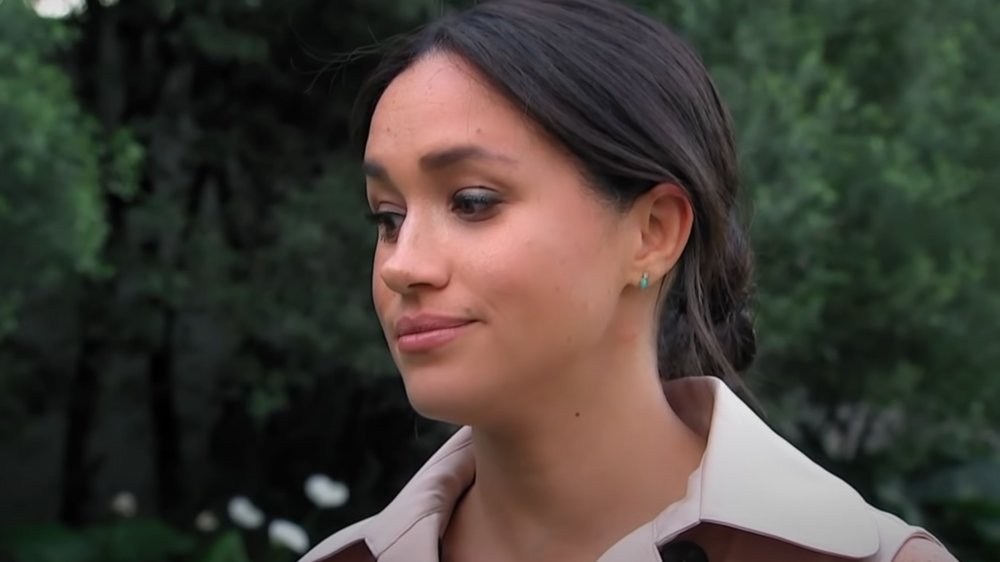 Meghan Markle  with hair pulled back in a low bun