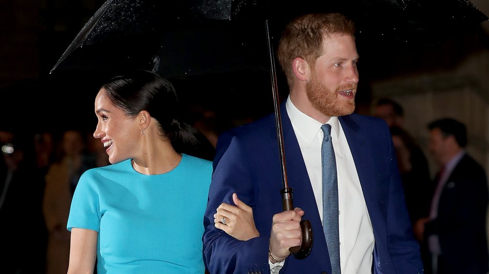 Meghan Markle and Prince Harry under an umbrella