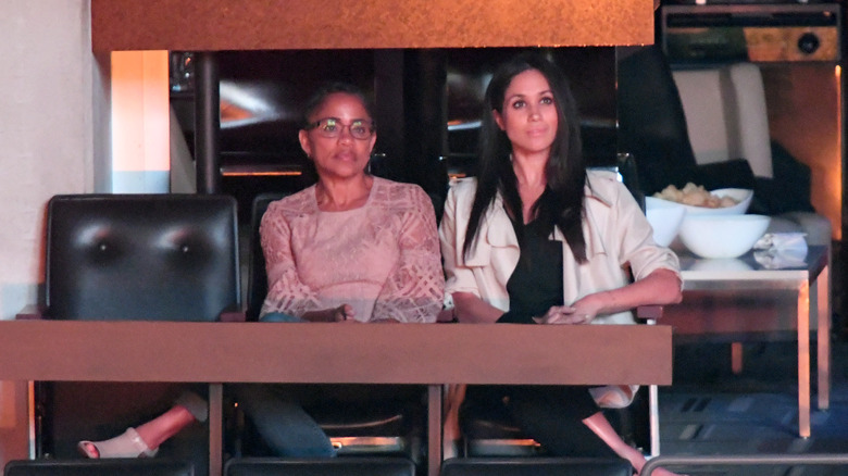 Meghan Markle and Doria Ragland smiling and seated