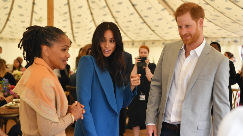 Doria Ragland with Meghan Markle and Prince Harry, talking