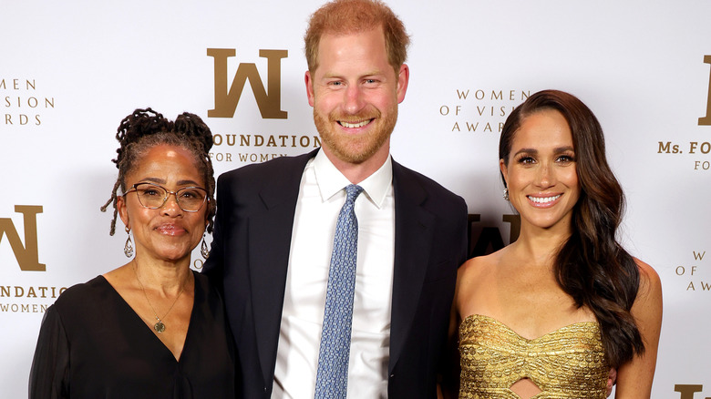 Doria Ragland with Meghan Markle and Prince Harry, all smiling