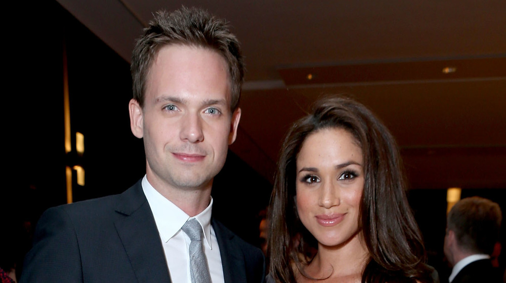 Patrick J. Adams and Meghan Markle smiling at an event