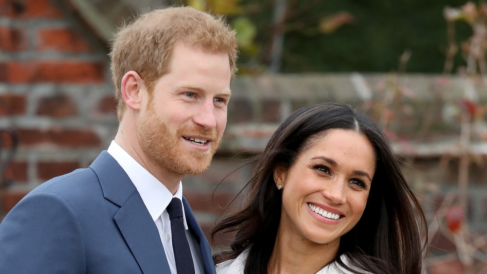 Prince Harry and Meghan Markle smiling for the cameras