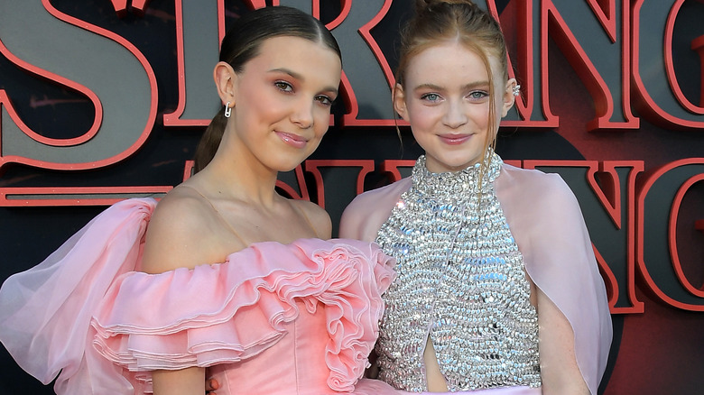 Millie Bobby Brown and Sadie Sink smile