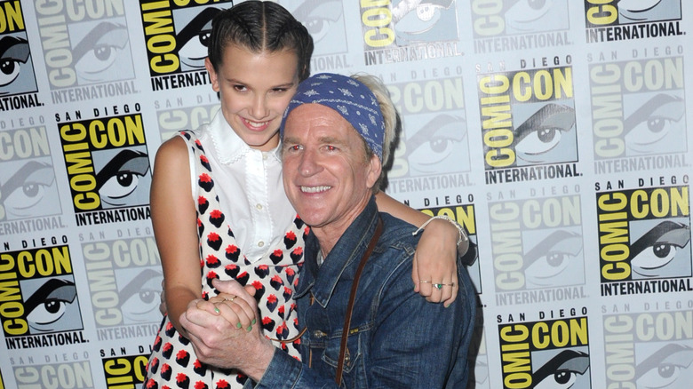 Millie Bobby Brown and Matthew Modine holding hands