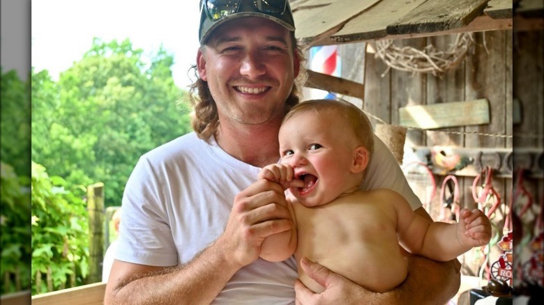 Morgan Wallen posing with son