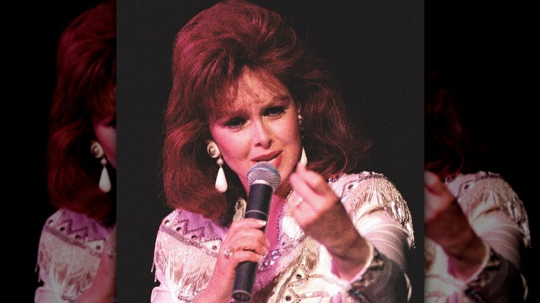 Naomi Judd holding microphone